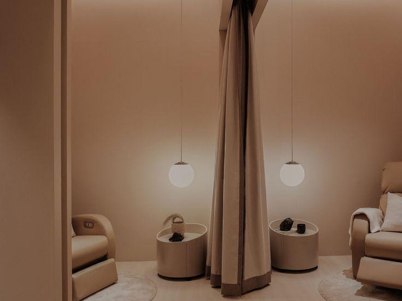 Concept image of a VIP treatment room with a central fabric partition, spherical pendant lights and treatment chairs