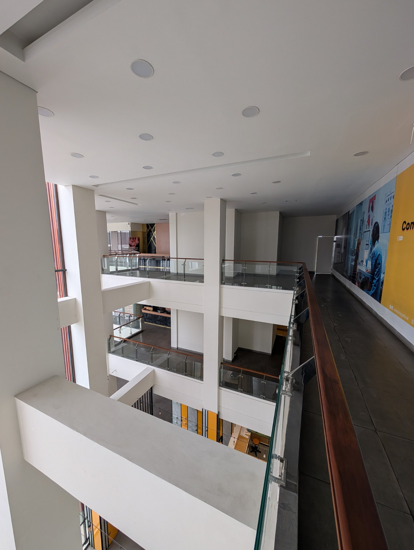 Building atrium with glass-railed balconies connecting several floors