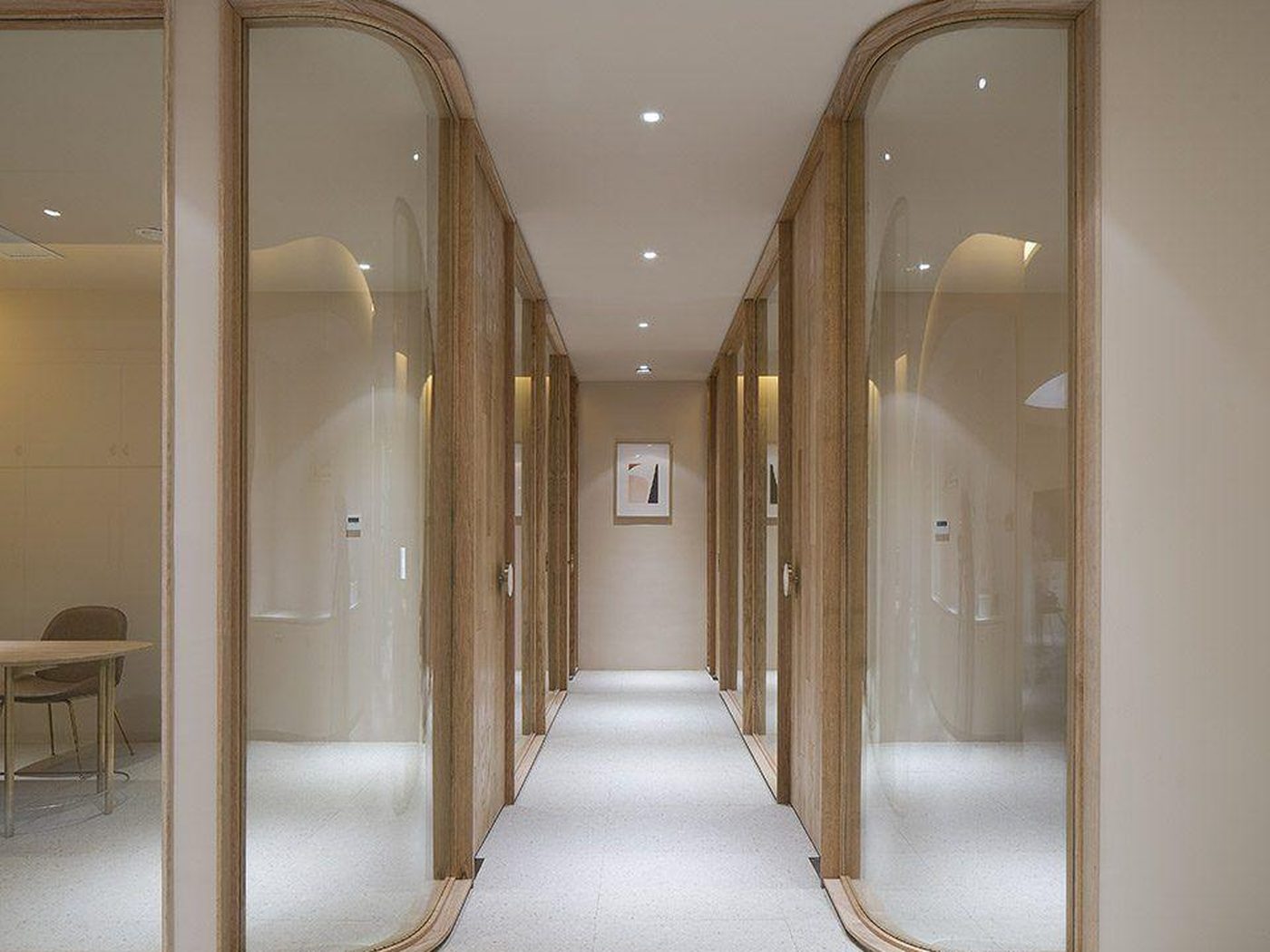 Concept image of a straight corridor lined with curved wood-framed glass doors on both sides
